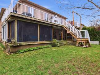 Enjoy outdoor living at its finest with this stunning property featuring a multi-level deck and screened-in porch.