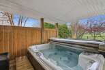 Relax and unwind in this luxurious hot tub, perfect for enjoying the outdoors in any season.