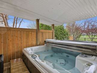Relax and unwind in this luxurious hot tub, perfect for enjoying the outdoors in any season.