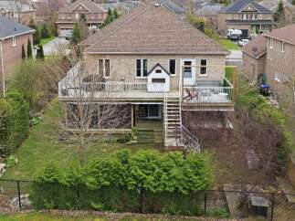 This stunning property boasts a spacious backyard with lush greenery and a charming deck, perfect for outdoor entertaining.