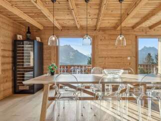 Experience luxury living in this stunning property featuring a dining area with breathtaking mountain views.