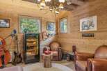 Step into a luxurious retreat with this stunning property, featuring a dedicated cigar room and a cozy seating area.