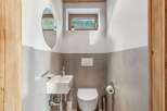 This charming bathroom features a modern design with a touch of rustic elegance.