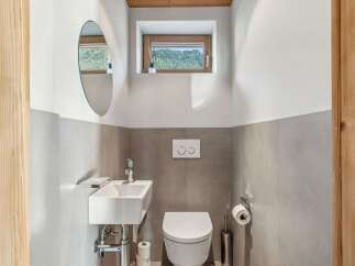 This charming bathroom features a modern design with a touch of rustic elegance.