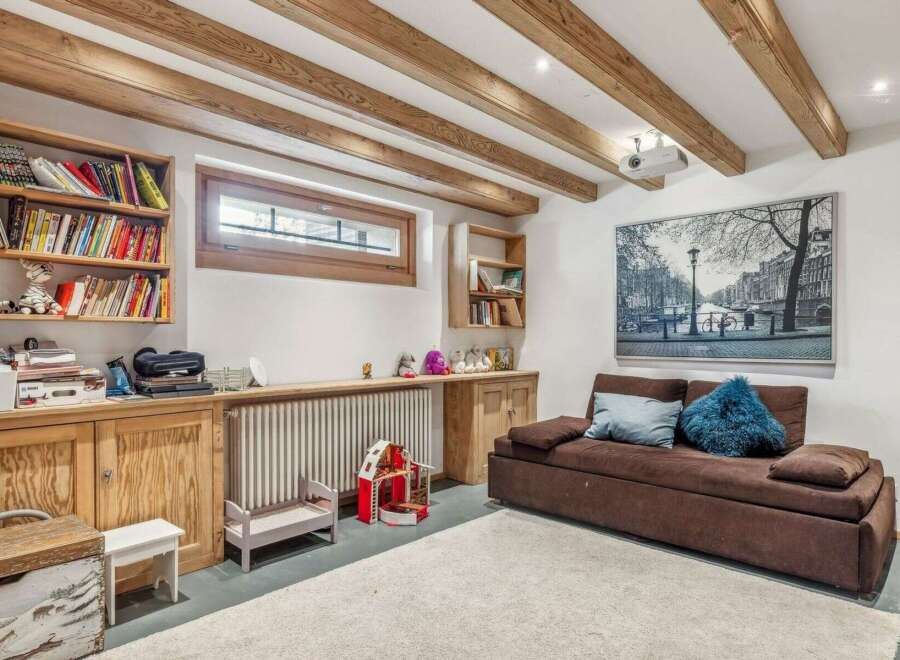 Discover the charm of this inviting living space, featuring exposed wooden beams that add warmth and character.