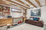 Discover the charm of this inviting living space, featuring exposed wooden beams that add warmth and character.