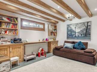 Discover the charm of this inviting living space, featuring exposed wooden beams that add warmth and character.