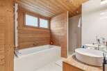 This stunning bathroom features a luxurious design with wooden walls and ceiling, creating a warm and inviting atmosphere.