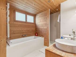 This stunning bathroom features a luxurious design with wooden walls and ceiling, creating a warm and inviting atmosphere.