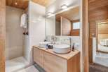 This stunning bathroom boasts a modern design with natural wood accents, creating a warm and inviting atmosphere.