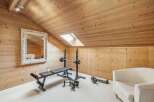 This stunning property boasts a dedicated home gym, perfect for fitness enthusiasts.