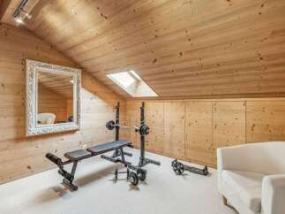This stunning property boasts a dedicated home gym, perfect for fitness enthusiasts.