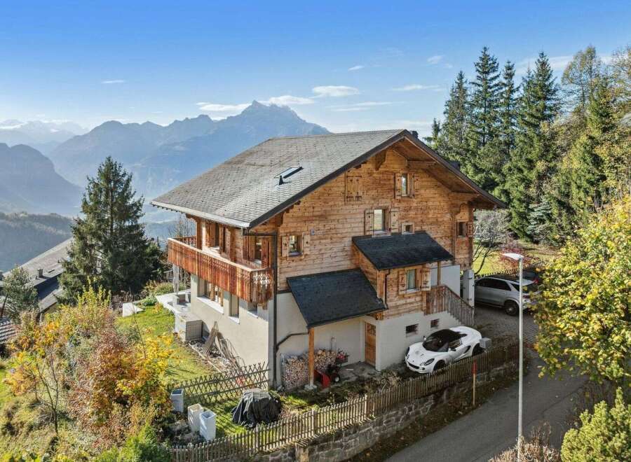 Discover your dream home in the mountains! This stunning property boasts a beautiful wooden exterior, offering a warm and inviting atmosphere.