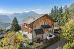 Discover your dream home in the mountains! This stunning property boasts a beautiful wooden exterior, offering a warm and inviting atmosphere.