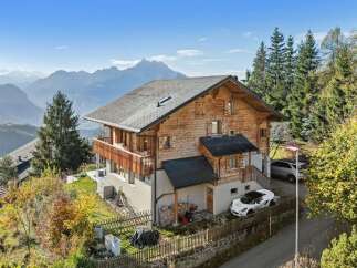 Discover your dream home in the mountains! This stunning property boasts a beautiful wooden exterior, offering a warm and inviting atmosphere.