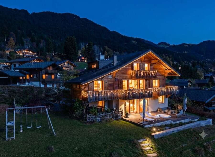 Experience luxury mountain living in this stunning chalet, beautifully illuminated with festive lights.