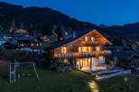 Experience luxury mountain living in this stunning chalet, beautifully illuminated with festive lights.