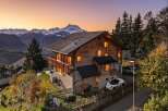 Experience breathtaking mountain views from this stunning wooden chalet, perfect for a serene getaway.
