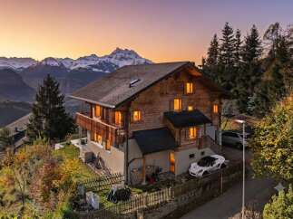 Experience breathtaking mountain views from this stunning wooden chalet, perfect for a serene getaway.