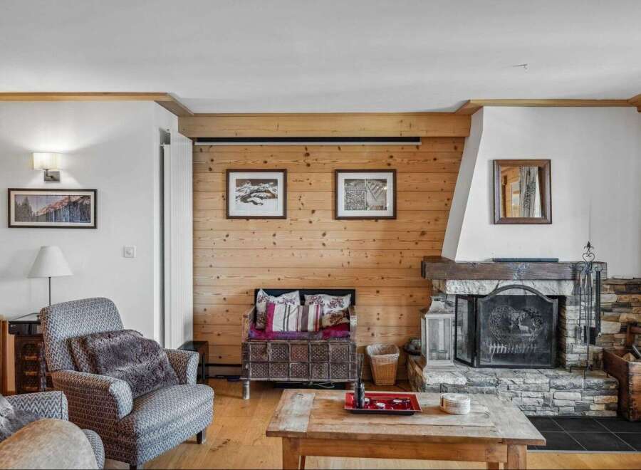 This cozy living room features a rustic fireplace, perfect for those chilly evenings.