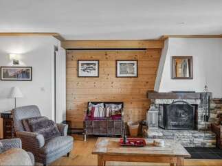 This cozy living room features a rustic fireplace, perfect for those chilly evenings.