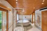 Step into luxury with this stunning bathroom featuring a circular jacuzzi and a separate shower.