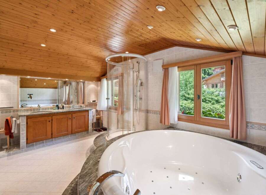 Indulge in luxury within this stunning bathroom, featuring a spacious jacuzzi tub and a separate shower.