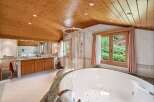 Indulge in luxury within this stunning bathroom, featuring a spacious jacuzzi tub and a separate shower.
