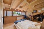 This stunning bedroom boasts a unique wooden design, creating a warm and inviting atmosphere.