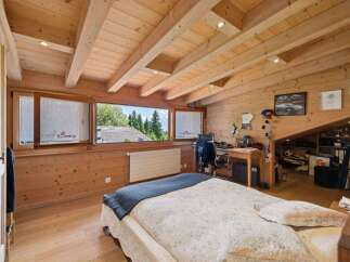 This stunning bedroom boasts a unique wooden design, creating a warm and inviting atmosphere.