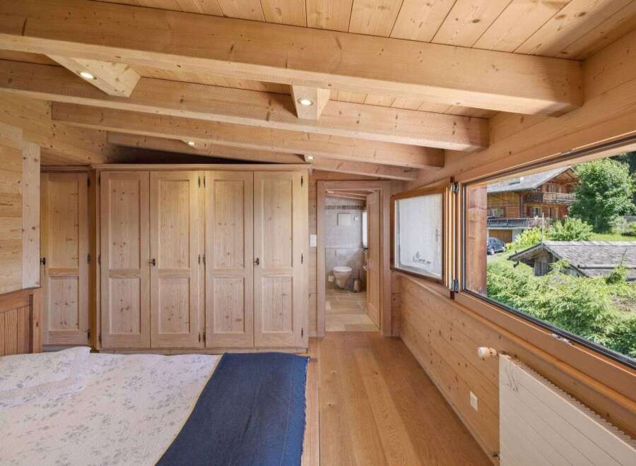 Experience the warmth and charm of this stunning wooden bedroom.