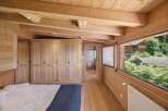 Experience the warmth and charm of this stunning wooden bedroom.
