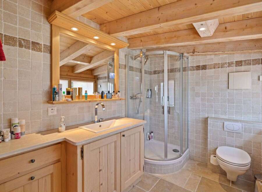 This stunning bathroom features a luxurious design with natural wood elements and a modern shower.