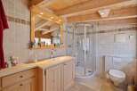 This stunning bathroom features a luxurious design with natural wood elements and a modern shower.
