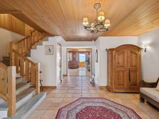 Step into luxury with this stunning property featuring a grand entrance and a beautiful staircase.