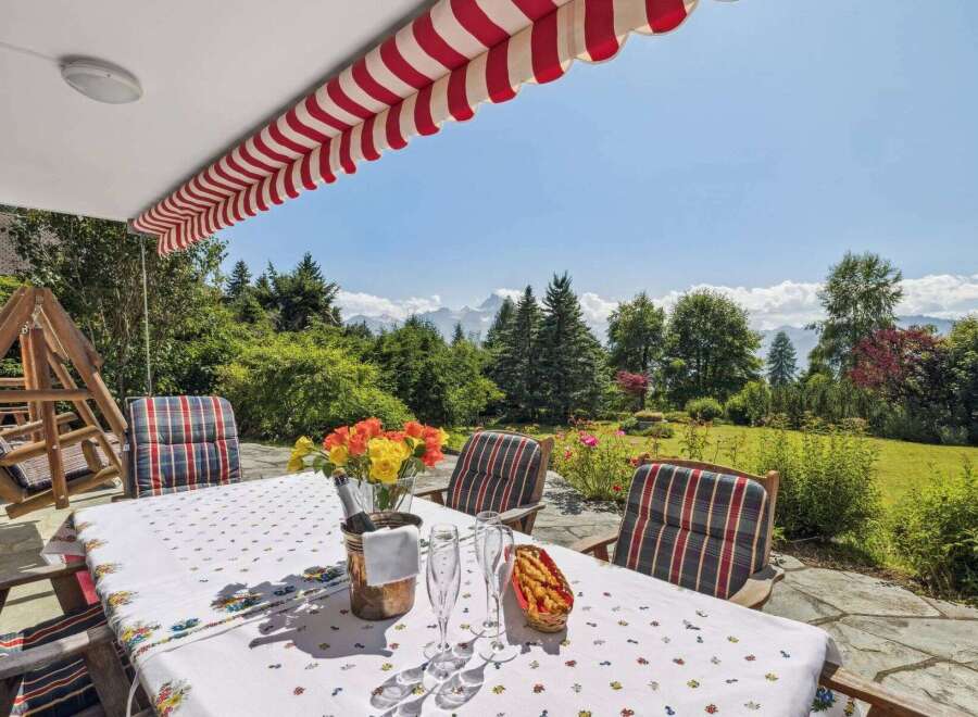 Enjoy breathtaking mountain views from this charming outdoor dining area.