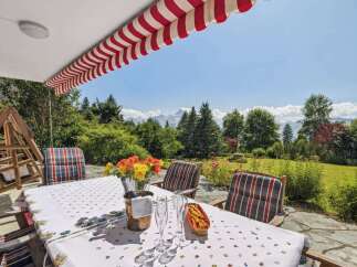 Enjoy breathtaking mountain views from this charming outdoor dining area.