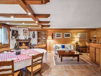 Step into a cozy retreat with this charming property, featuring a rustic interior design.