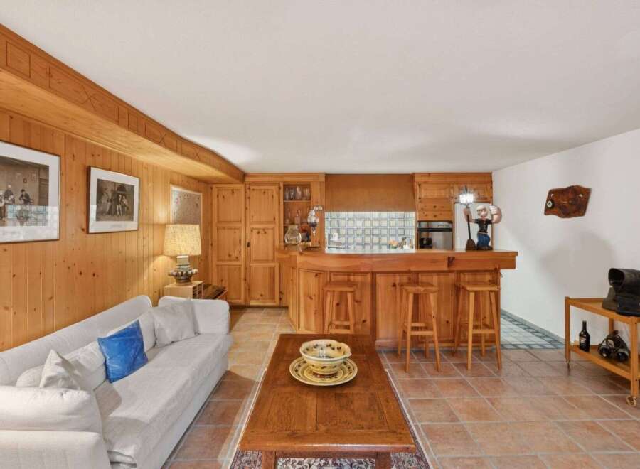 Step into this charming home featuring a cozy living space with a rustic wooden interior.