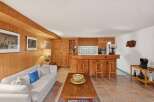 Step into this charming home featuring a cozy living space with a rustic wooden interior.