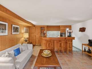 Step into this charming home featuring a cozy living space with a rustic wooden interior.