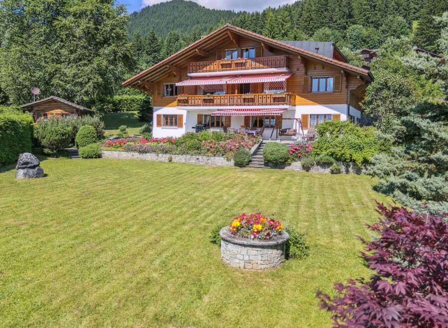 Discover the charm of this stunning property, featuring a beautifully designed wooden house with multiple levels and balconies.