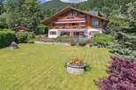 Discover the charm of this stunning property, featuring a beautifully designed wooden house with multiple levels and balconies.