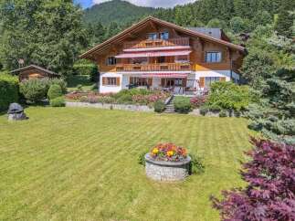 Discover the charm of this stunning property, featuring a beautifully designed wooden house with multiple levels and balconies.