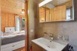 Discover the charm of this cozy property, featuring a beautifully designed bathroom with a modern sink and a stylish mirror.