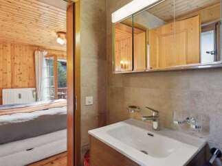 Discover the charm of this cozy property, featuring a beautifully designed bathroom with a modern sink and a stylish mirror.