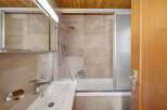 Step into a beautifully designed bathroom featuring a sleek shower enclosure and a modern sink.