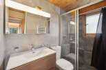 This modern bathroom features a sleek design with a spacious vanity and a contemporary faucet.