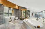Indulge in luxury within this stunning bathroom, featuring a sleek design and high-end finishes.