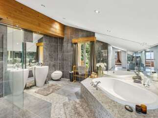 Indulge in luxury within this stunning bathroom, featuring a sleek design and high-end finishes.